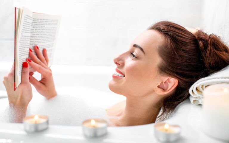 A woman reading a book in a bubble bath